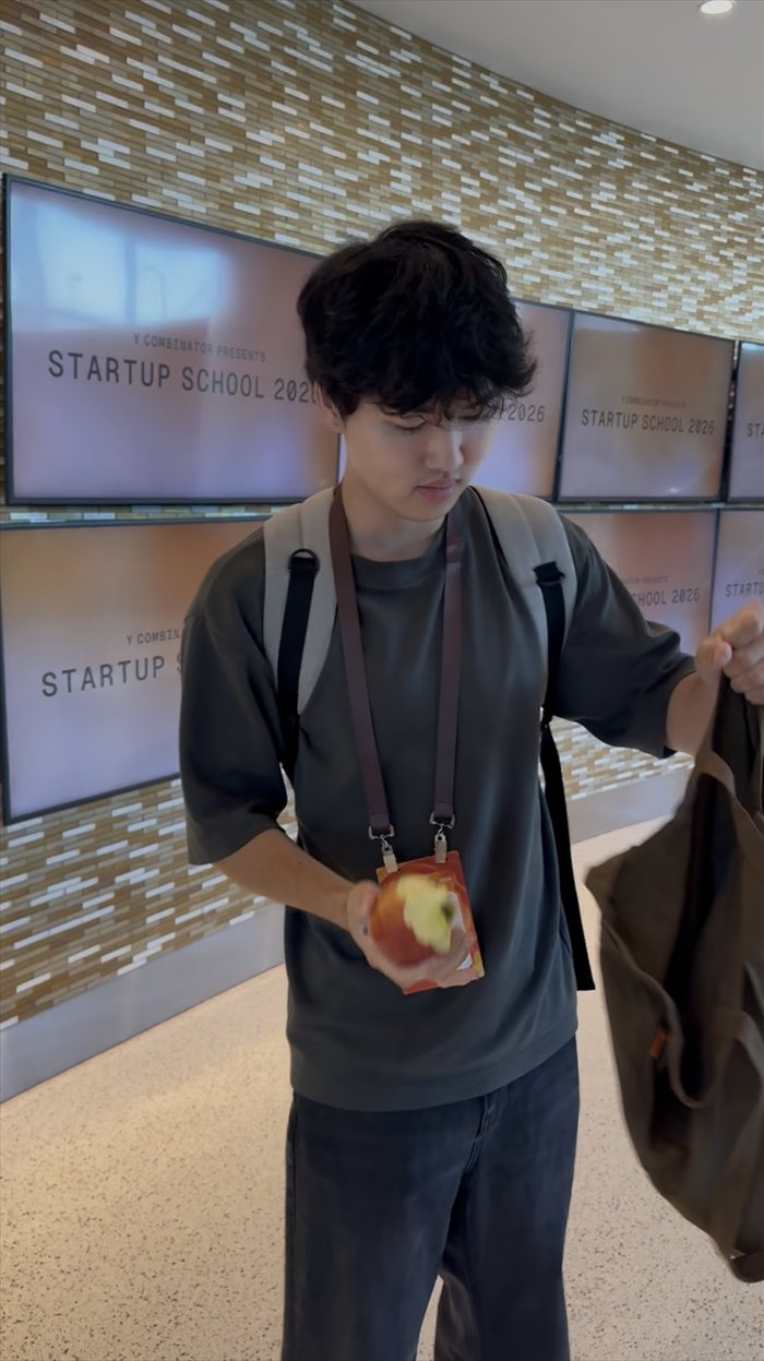 Brandon Lee in front of the Y Combinator Startup School 2026 screens