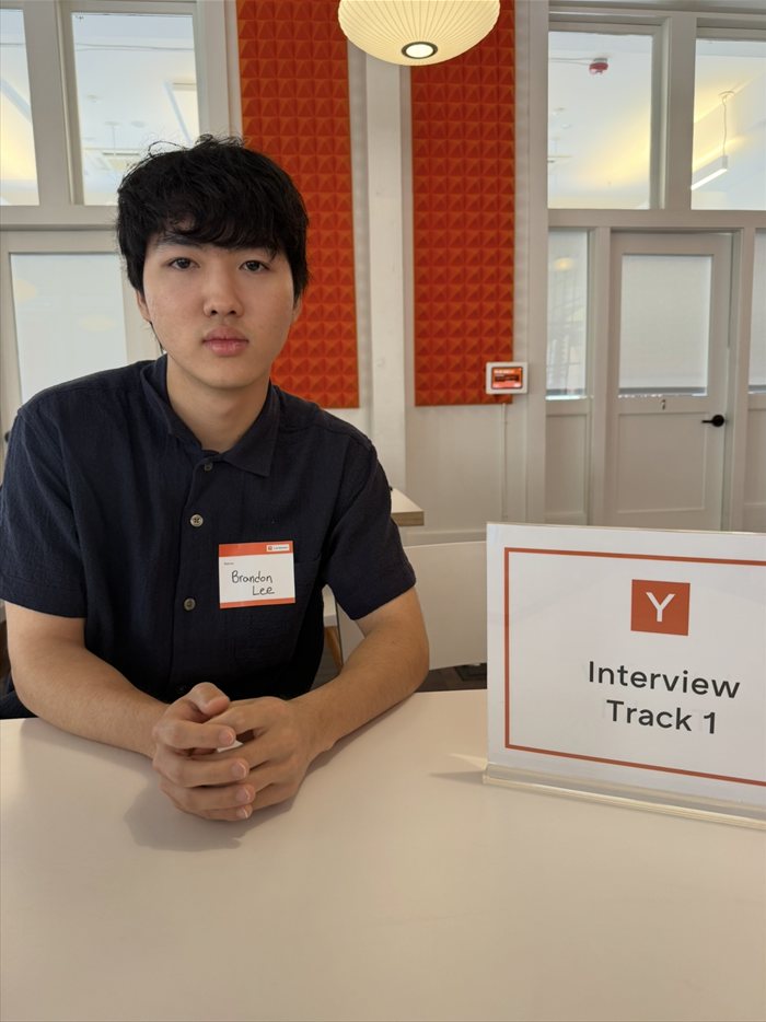 Brandon Lee seated at the Interview Track 1 table at Y Combinator